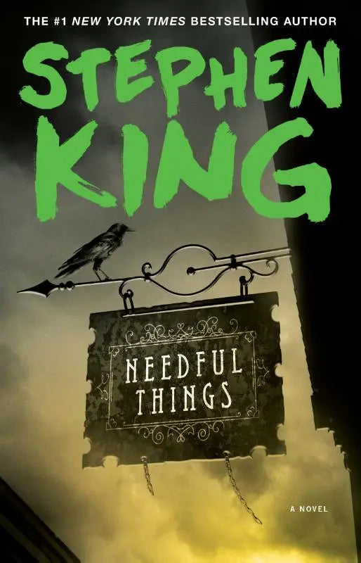 The book cover of needful things by stephen king features a dark ornate sign with white lettering on black background