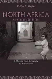 De boekomslag van north africa revised edition toont een donkere illustratie van een bewerkte deur met een figuur in witte kleding ervoor