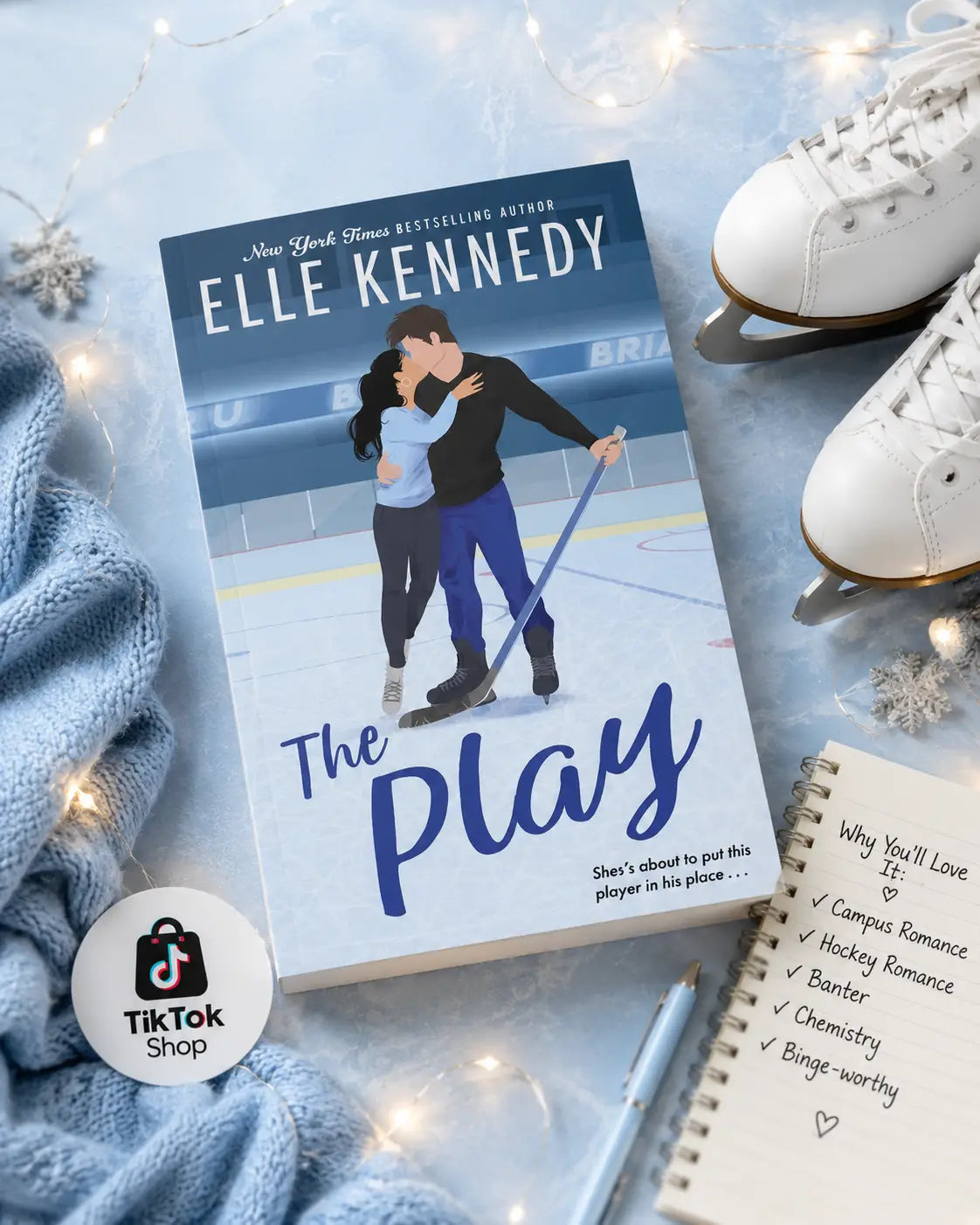 The play by elle kennedy paperback with blue and white cover featuring an illustrated couple ice skating