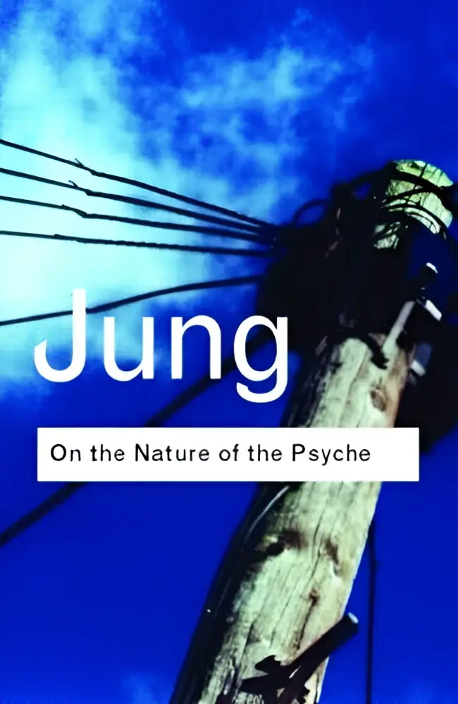 The nature of the psyche book cover with white text on blue sky and aged wooden utility pole with wires
