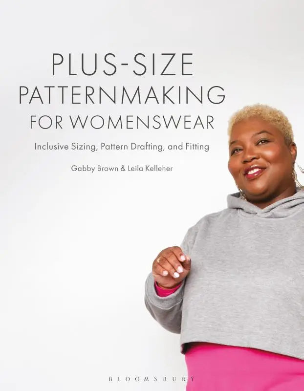 A smiling woman wearing a gray cropped hoodie and bright pink pants demonstrating inclusive sizing patternmaking for womenswear