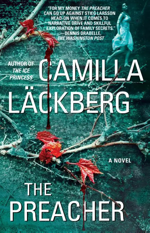 Het boek preacher a novel van camilla läckberg met een donkergroene en rode omslag en herfstbladeren