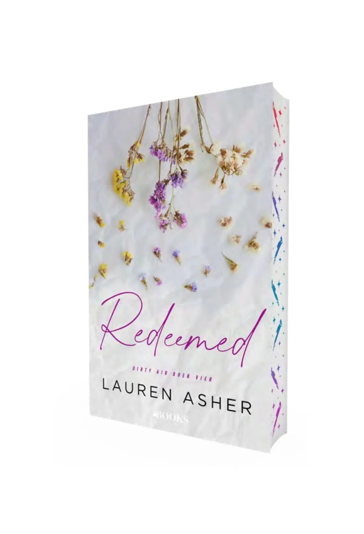 Witte hardcover boek redeemed van lauren asher met droogbloemen in zachte gele, paarse en roze tinten op de omslag