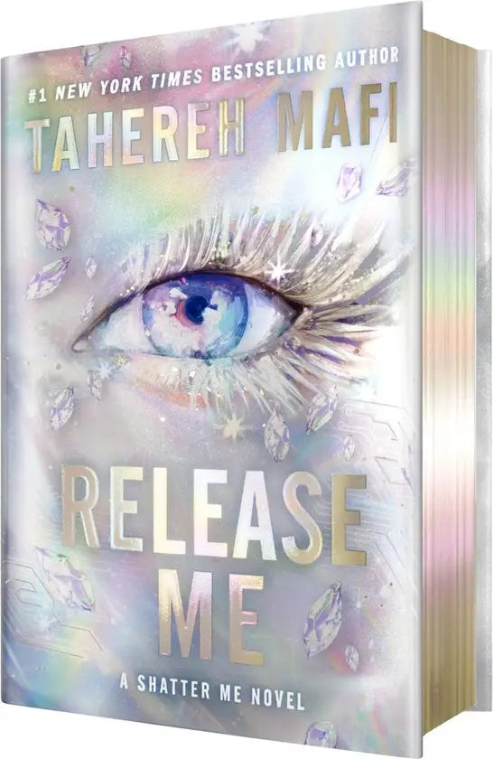 De deluxe limited edition van release me door tahereh mafi heeft een zilveren omslag met een oog en fonkelende diamanten