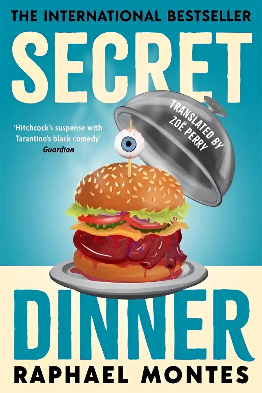 A cartoonish secret dinner burger with sesame buns, lettuce, tomato, cheese, meat, topped with a blue eyeball under a silver cloche