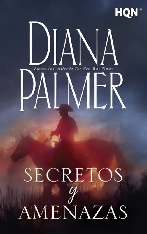 De boekcover van secretos y amenazas toont een silhouet van een vrouw te paard tegen een vurige lucht