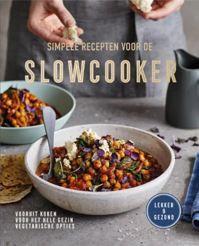 Een rustieke wit gespikkelde keramische kom met een kleurrijke kikkererwten- en groentestoverij voor simpele recepten