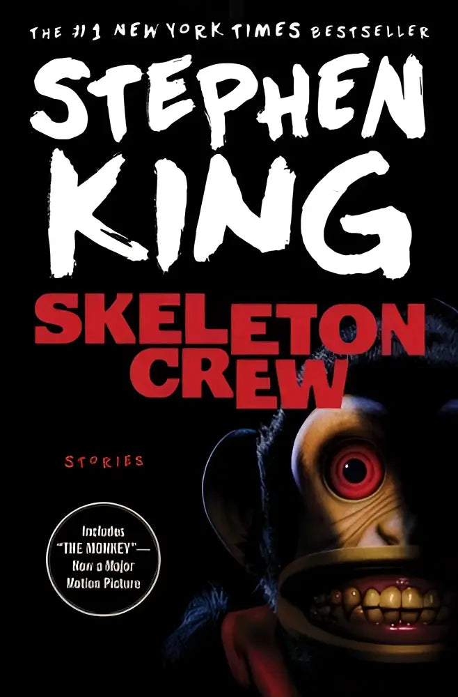 The cover of stephen king’s skeleton crew book features a menacing monkey with red eyes and yellow teeth on black background