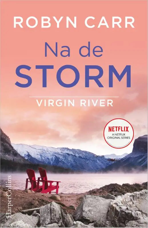 Rode houten adirondack stoelen op een rotsachtige oever naast een mistig meer na de storm