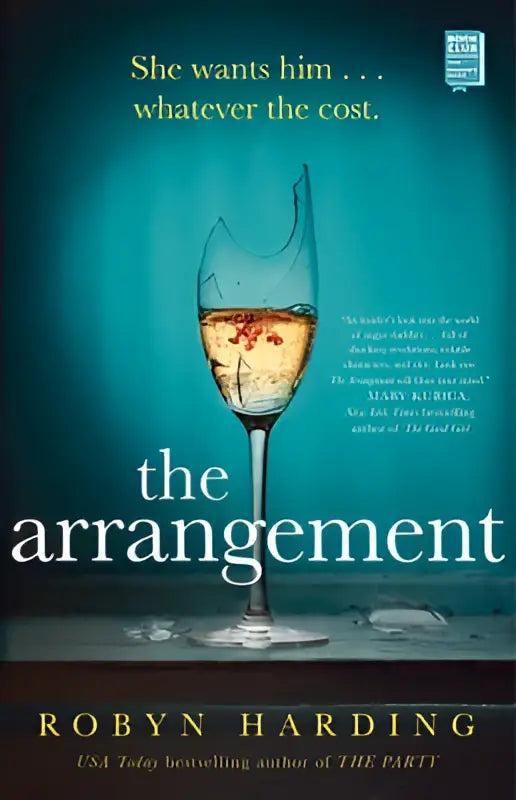 A shattered wine glass filled with golden liquid on a dark surface from the arrangement product line
