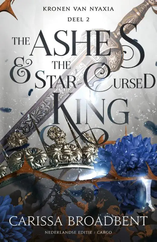The ornate silver sword with filigree detail rests diagonally on the cover of the ashes and the star cursed king by carissa broadbent