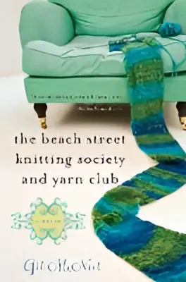 A teal knitted blanket with a blue-green gradient and intricate pattern from the beach street knitting society and yarn club