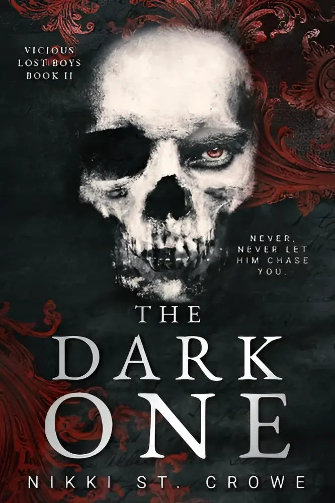 De cover van the dark one toont een witte schedel met rood gloeiend oog en rode ornamenten voor een peter pan dark romance boek