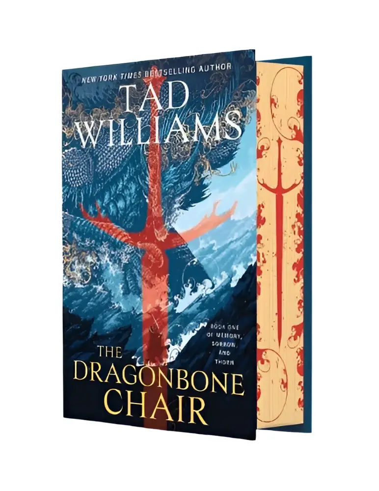 The dragonbone chair hardcover book with a red dragon skeleton illustration on a blue and gold cover