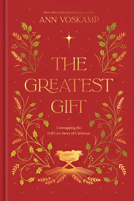 Rode hardcover boek the greatest gift van ann voskamp met goudfolie tekst en bloemmotieven over kerstliefde verhaal