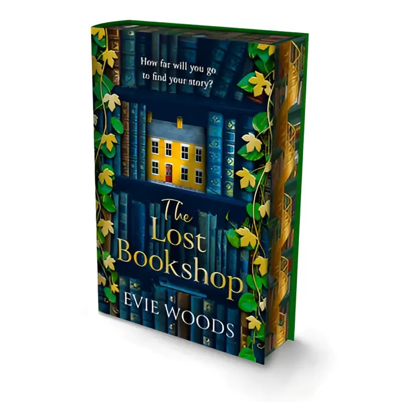 The lost bookshop deluxe edition hardcover with dark blue cover featuring yellow house illustration among green vines and books