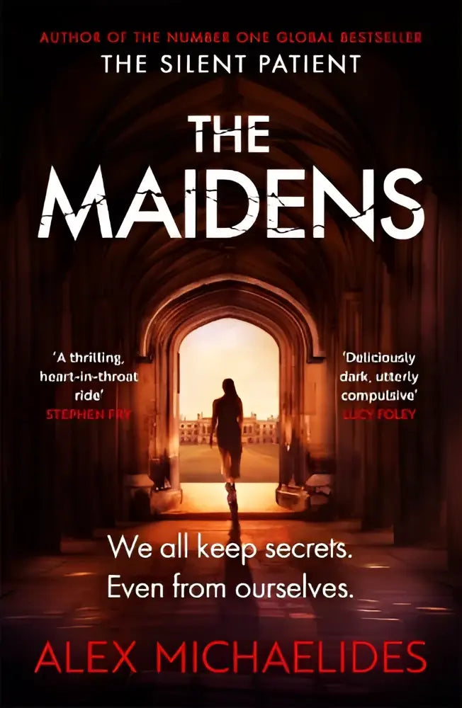 De boekomslag van the maidens door alex michaelides toont een donkere gotische boog met warm gouden licht binnenin