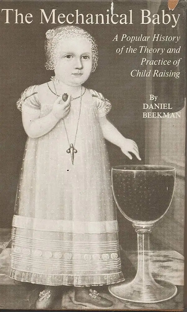 The mechanical baby book cover shows a sepia portrait of a child in lace dress holding a scissors pendant for theory and practice