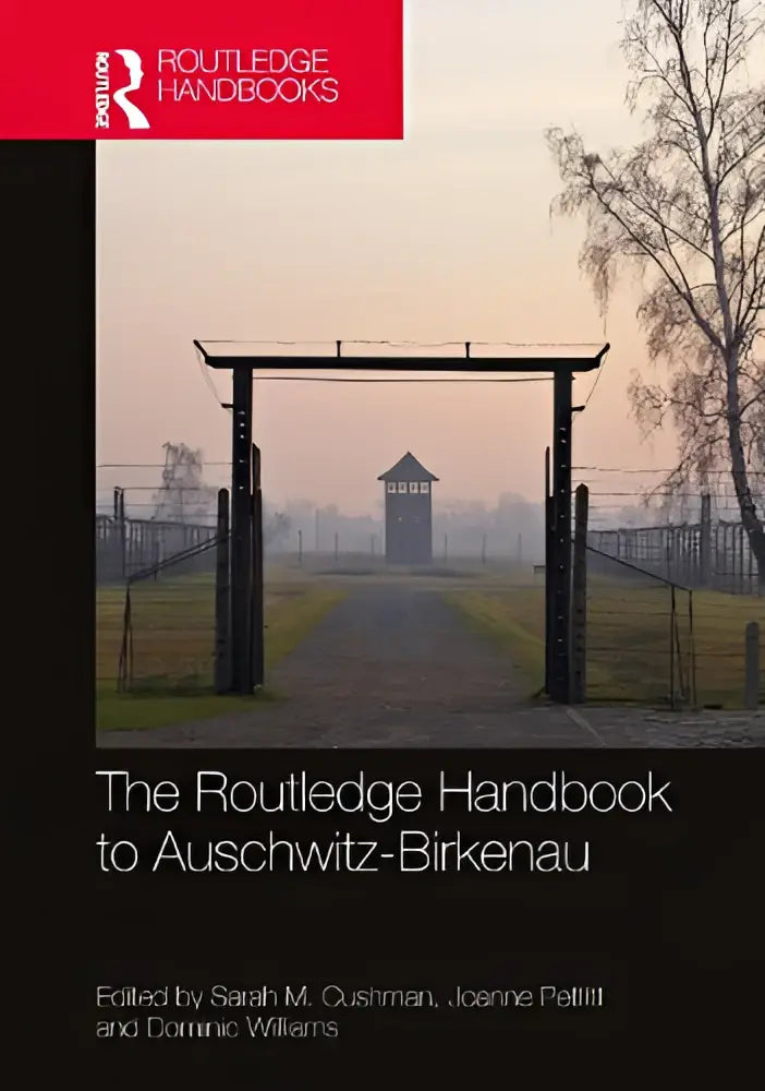 The routledge handbook to auschwitz-birkenau hardcover book with black and red cover featuring misty concentration camp entrance