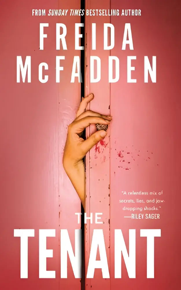 The tenant by freida mcfadden paperback with pink cover showing a hand gripping wooden slats and bloodstains sunday times bestseller