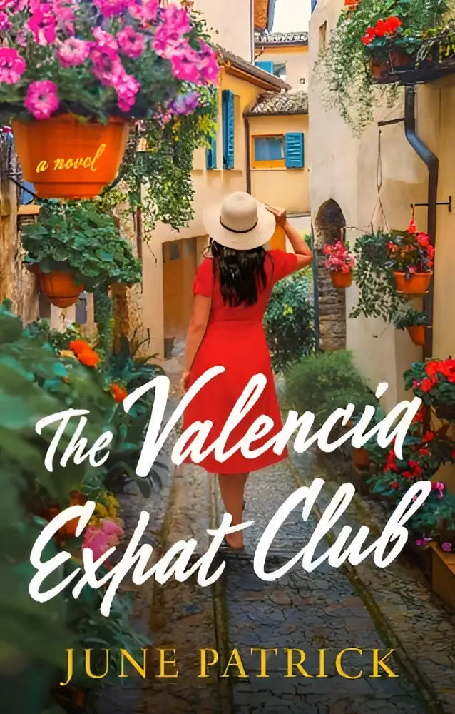 A woman in a red dress and wide-brimmed hat walks a cobblestone alley in the valencia expat club novel cover