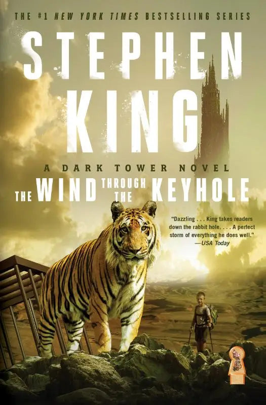 The wind through the keyhole book cover showing a large orange and black tiger on rocky terrain in a dark tower novel
