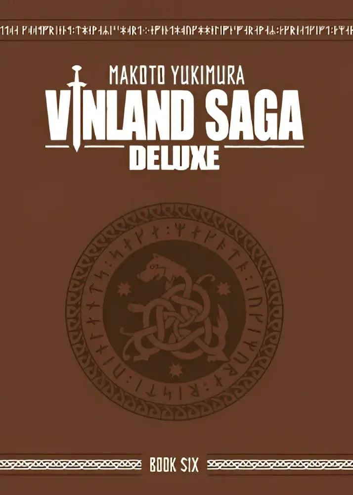 De cover van vinland saga deluxe 6 met een bruine achtergrond, witte en gouden tekst en een noorse draakrunenembleem