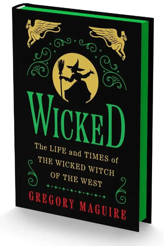 Zwarte hardcover boek wicked collectors edition met groene rug en gouden heksen- en griffioenillustraties tegen gele maan