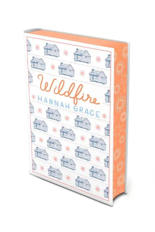 White deluxe edition hardcover of wildfire the instant global bestseller with orange spine and blue log cabin pattern